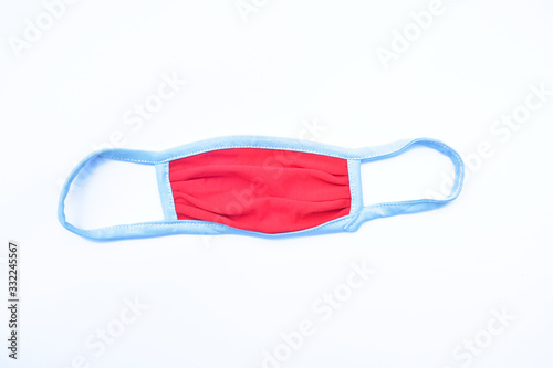 Red facial mask which is used is isolated on a light yellow background