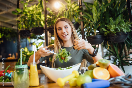 Positive trainer hold fresh salad for healthy care and body slim. Fitness instructor exercising the fitness. Diet and healthy sport concept