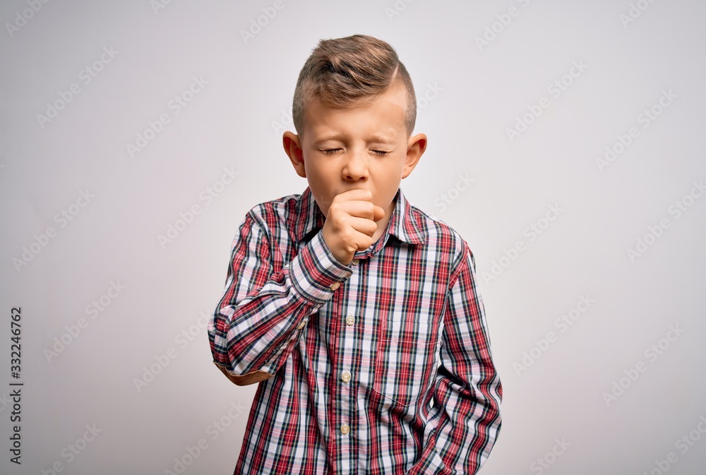 Young little caucasian kid with blue eyes wearing elegant shirt standing over isolated background feeling unwell and coughing as symptom for cold or bronchitis. Health care concept. Young little caucasian kid with blue eyes wearing elegant shirt standing over isolated background feeling unwell and coughing as symptom for cold or bronchitis. Health care concept.