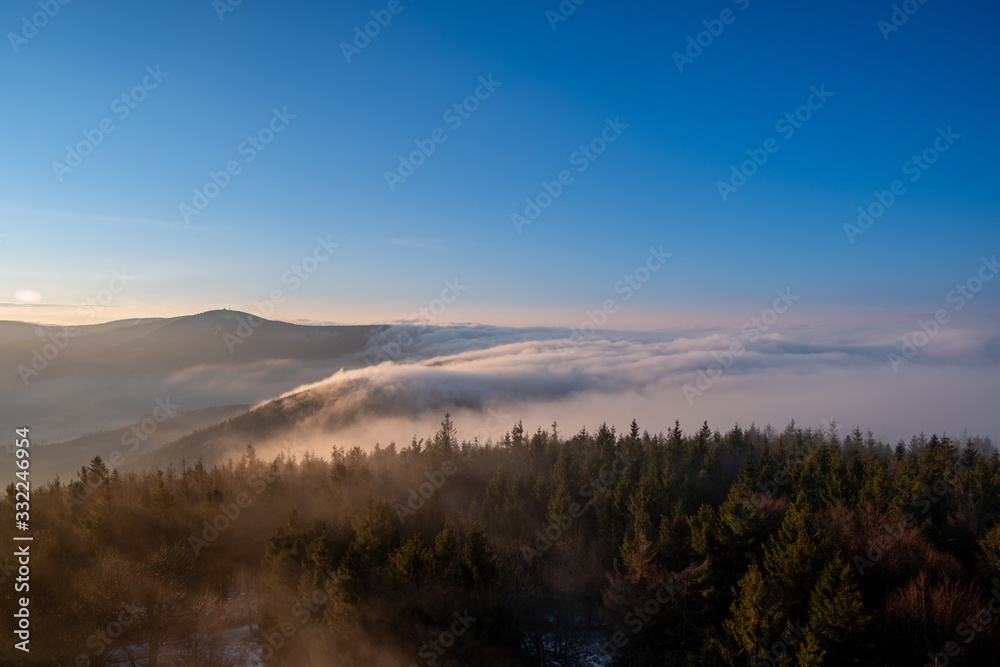 Sunrise in mountains in spring with fog and beautiful forest, Czech Beskydy