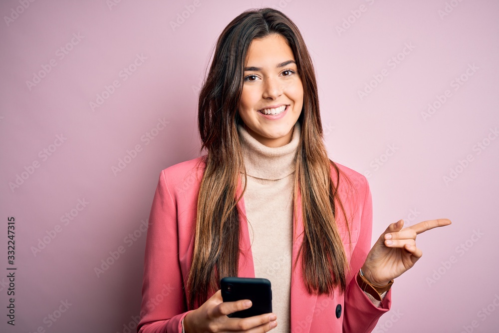 Young beautiful girl having conversation using smartphone over white background very happy pointing with hand and finger to the side Young beautiful girl having conversation using smartphone over white background very happy pointing with hand and finger to the side