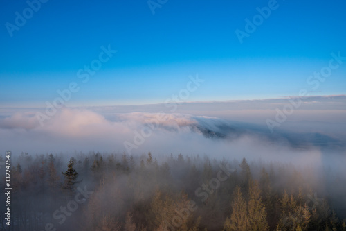 fog rolling in the mountains over the hills at sunrise, Czech Beskydy