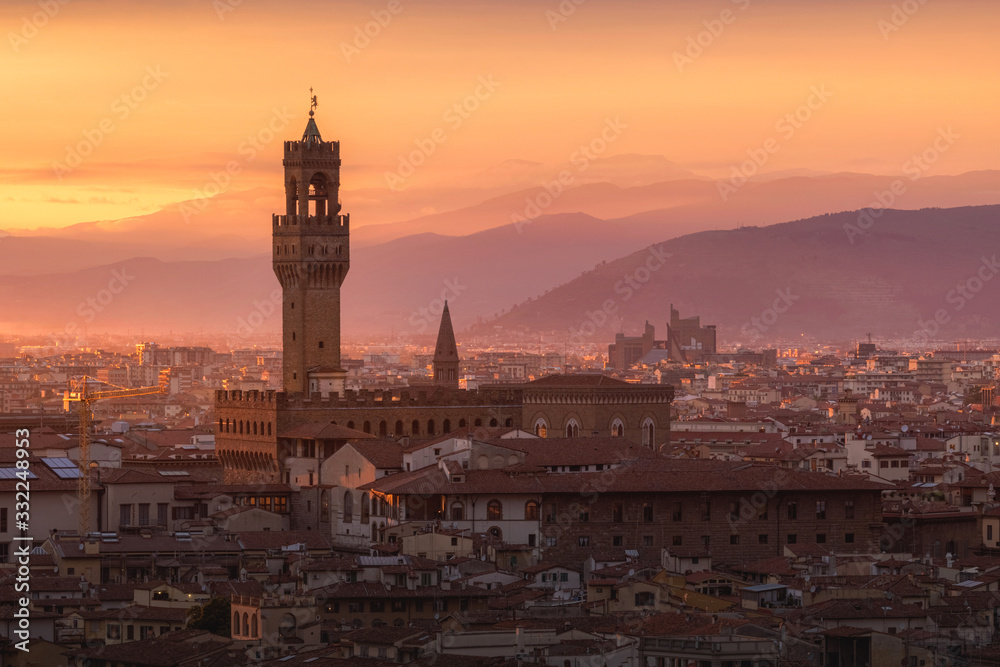 Cityscape of Florence with Palazzo Vecchio illuminated at the sunset light