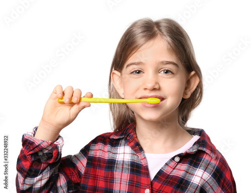 Cute little girl with toothbrush on white background