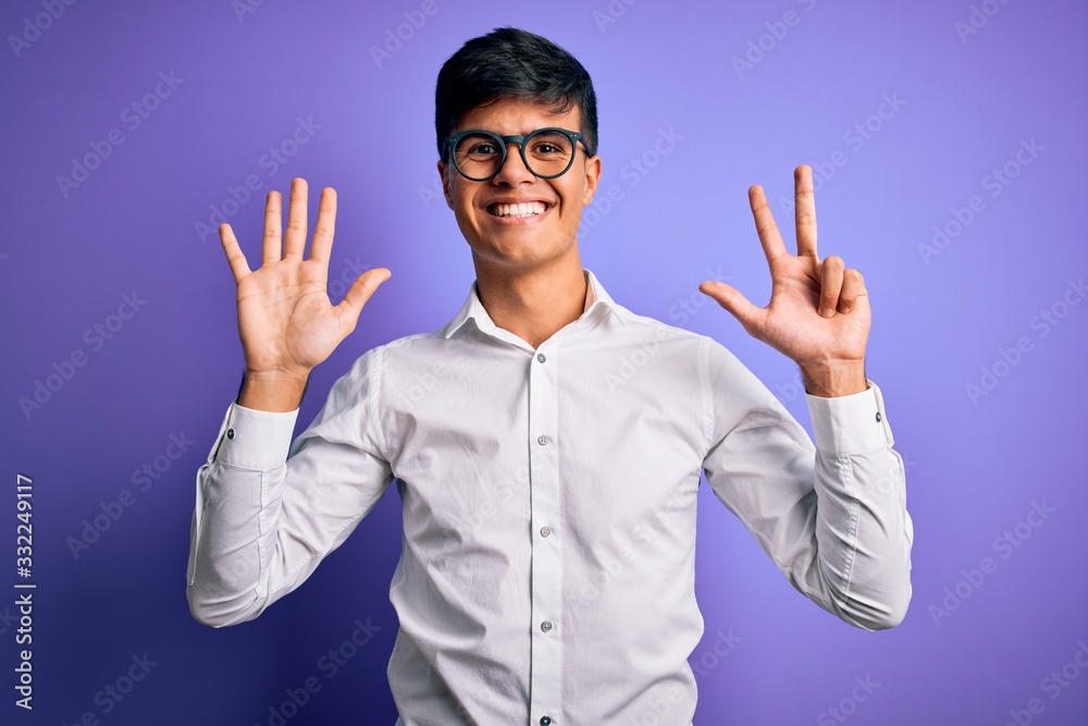 Naklejka premium Young handsome business man wearing shirt and glasses over isolated purple background showing and pointing up with fingers number eight while smiling confident and happy.