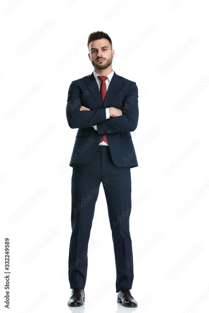 formal man standing with hands crossed and striking a pose formal man standing with hands crossed and striking a pose