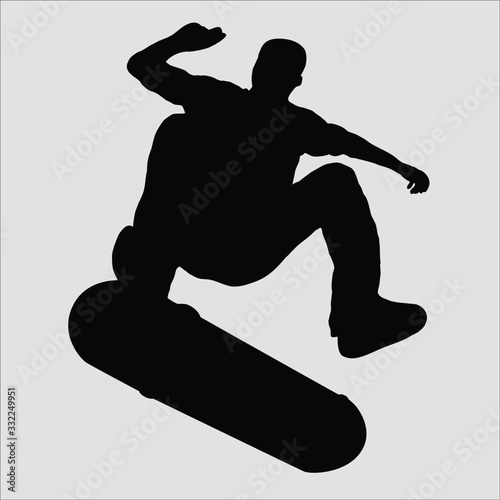 Grey silhouette of jumping skateboarder