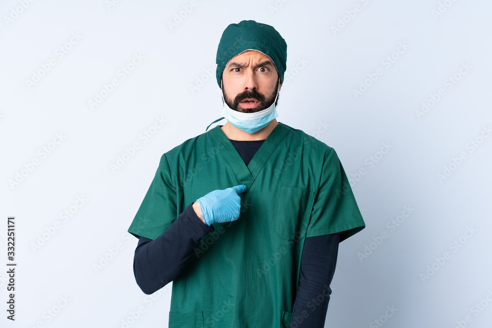 Surgeon man in green uniform over isolated background pointing to oneself Surgeon man in green uniform over isolated background pointing to oneself