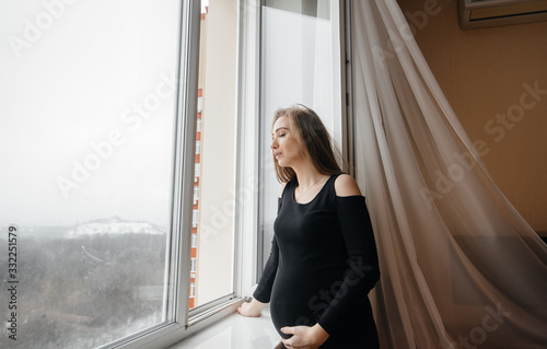 Free Download A pregnant girl is breathing fresh air from the window - GFXLoad