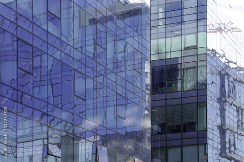 Abstract architecture. Glass blue square Windows of facade modern city business building skyscraper. The texture of the windows of the building.