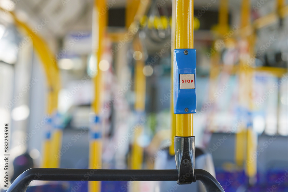 Yellow stop button for bus or tram. Press the button to request the bus driver for get off at the next station. Public transport transfer. Yellow stop button for bus or tram. Press the button to request the bus driver for get off at the next station. Public transport transfer.