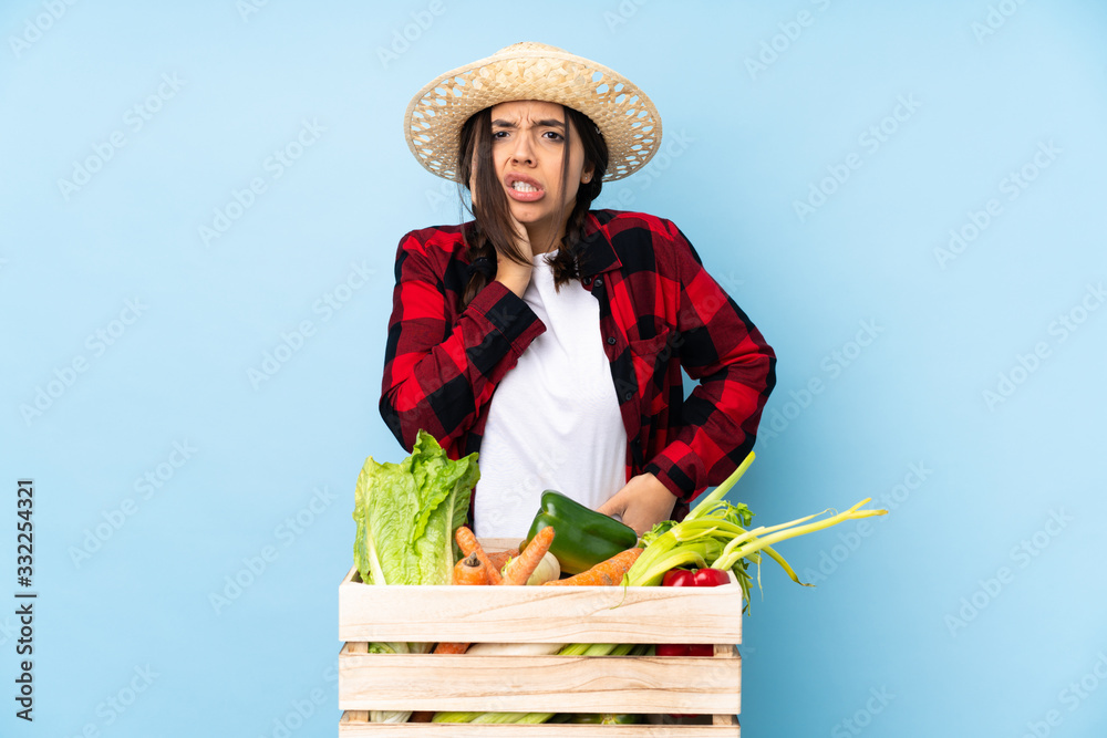 Young farmer Woman holding fresh vegetables in a wooden basket with toothache