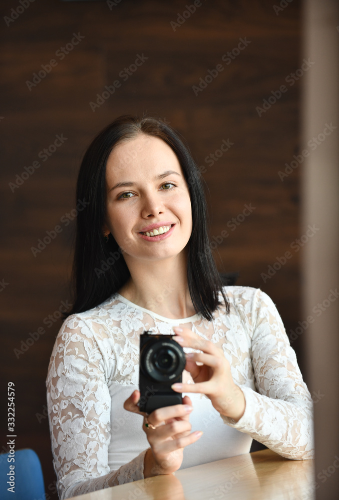 Young woman photographer with digital camera 