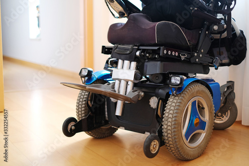 Blue electric wheelchair for disabled people - indoors