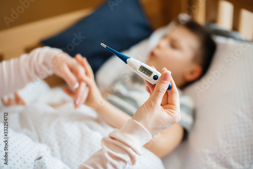 Thermometer close- up during the child's illness . The virus and the epidemic