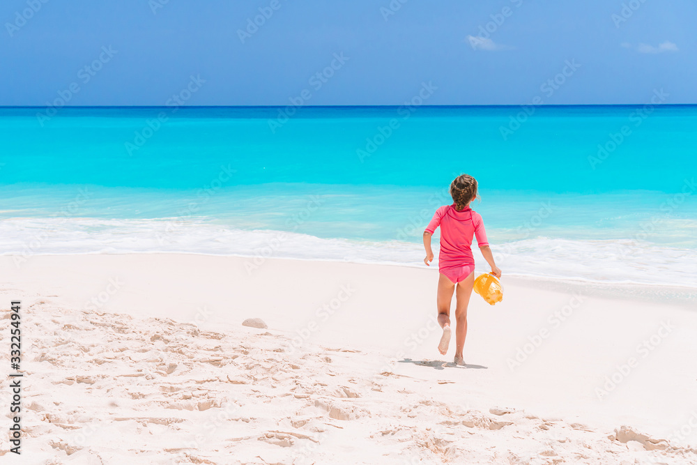 Portrait of adorable little girl at beach during summer vacation Portrait of adorable little girl at beach during summer vacation