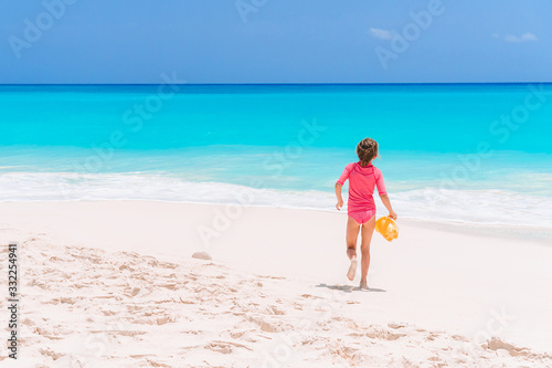 Portrait of adorable little girl at beach during summer vacation