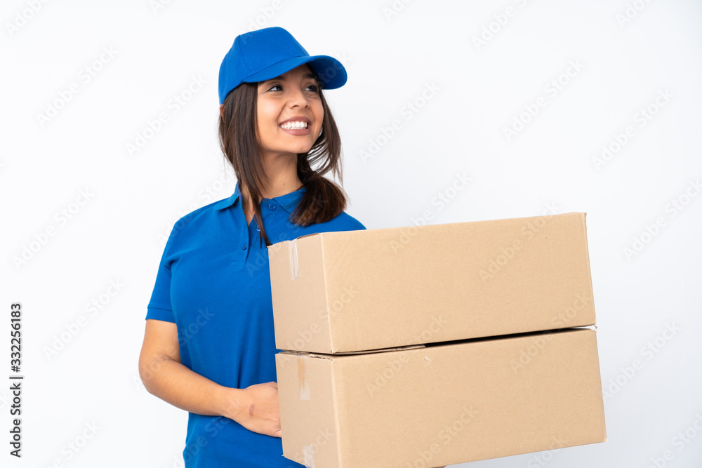 Young delivery brunette girl over isolated white background with arms crossed and happy Young delivery brunette girl over isolated white background with arms crossed and happy