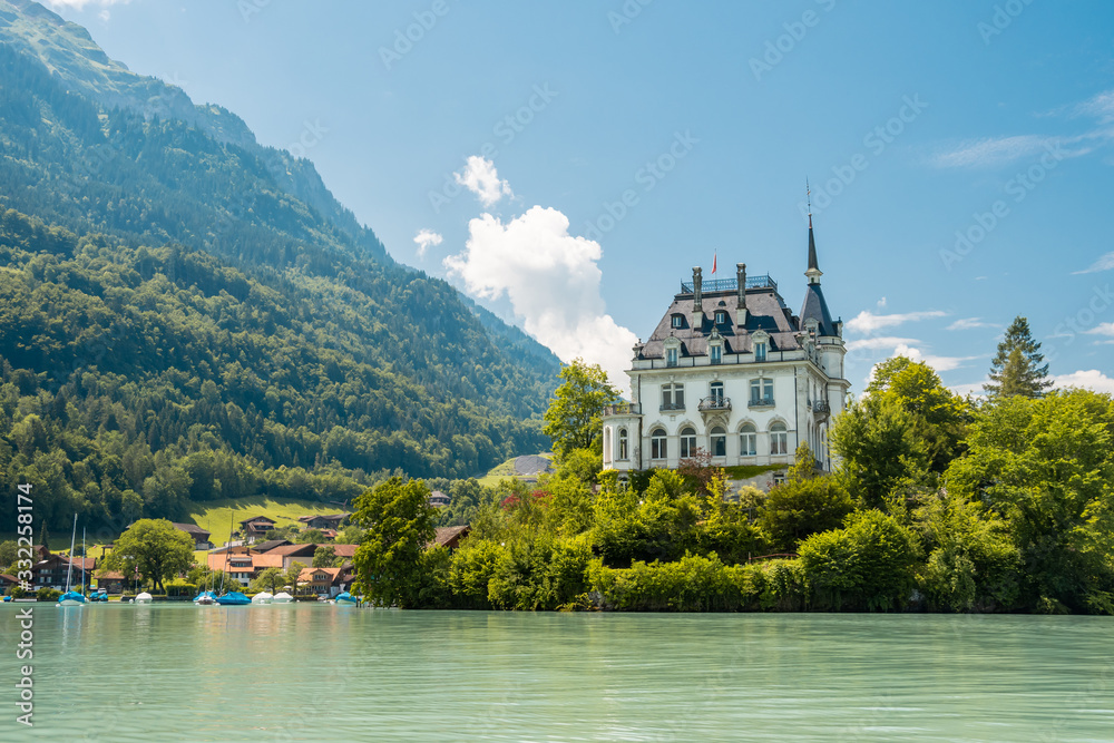 Schloss Seeburg. Seeburg castle was built on peninsula surrounded by the teal coloredwaters of lake Brienz. Iseltwald, Switzerland.