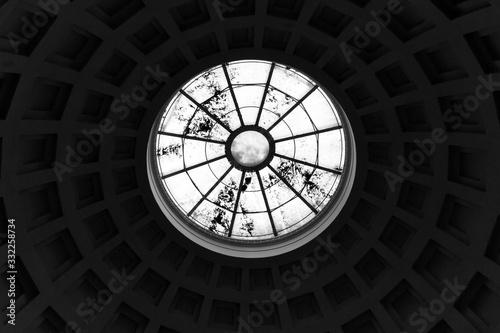 A view from inside the building onto a dome with caissons, which ends with a round window photo