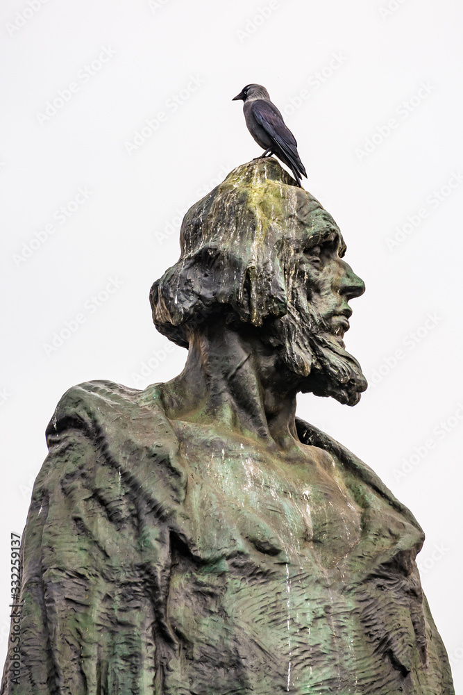 Fototapeta premium Prague, Czech republic - March 19, 2020. Statue of Mistr Jan Hus in empty Old Town Square during coronavirus crisis