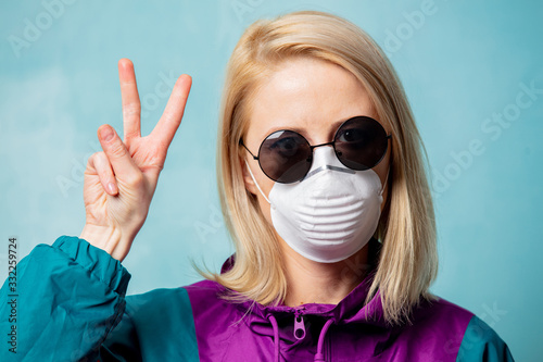 Blonde woman in face mask and 90s style clothes