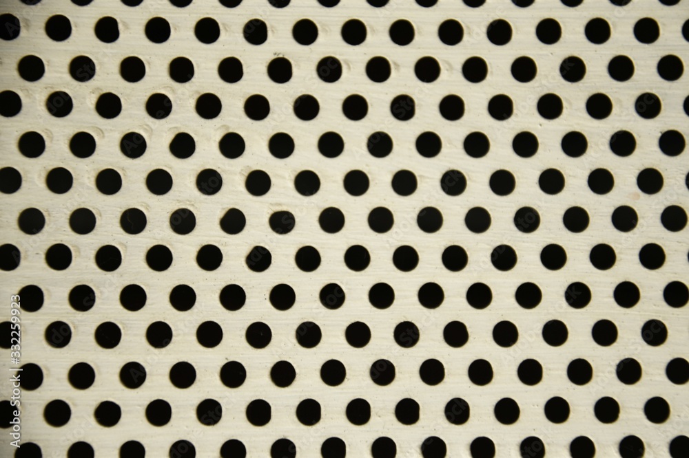 white background with black circular holes
