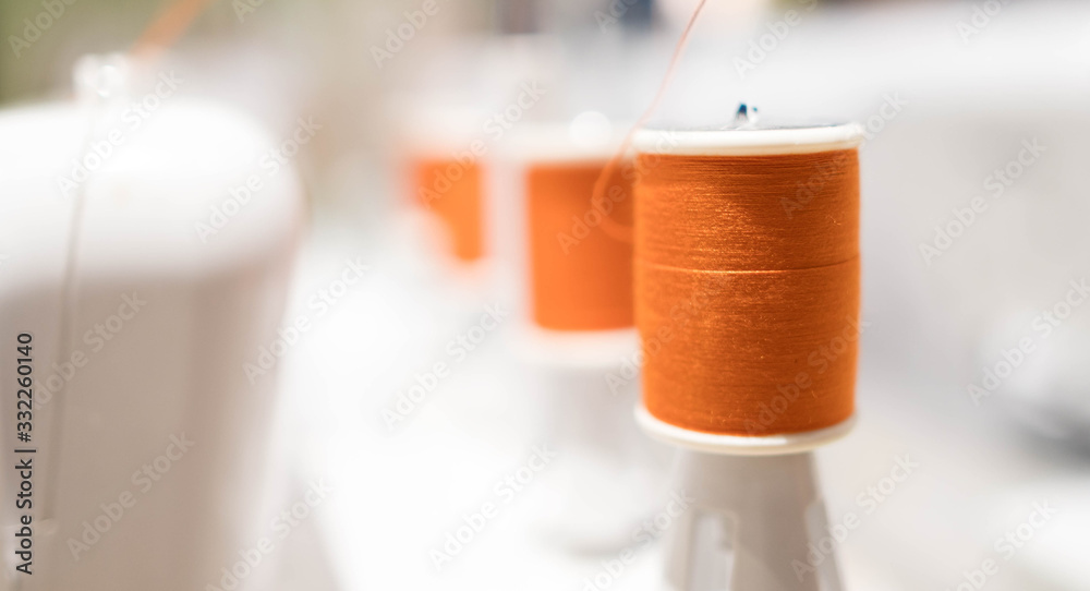 Reels of thread on Machine embroider on the table of new technology embroidering Reels of thread on Machine embroider on the table of new technology embroidering