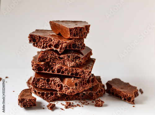 Chocolate on a white background, isolated. Porous Chocolate Texture