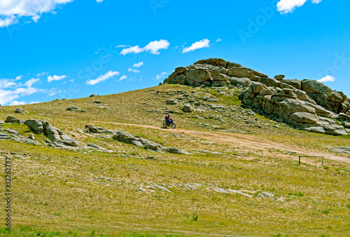 View of scenic Mongolian steppe, a homeland of Ginggis Khan and nomadic traditions photo