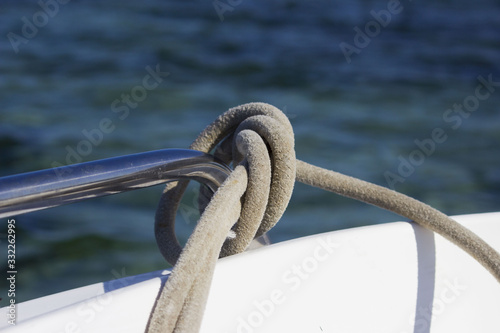 mooring rope tied by a sea knot on the railing of the boat. reportage shooting.
