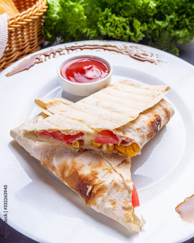 pita meat roll with chicken meat tomato cheese and corn