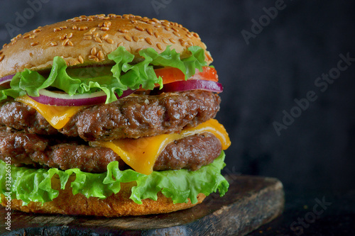 Burger with two beef patties and cheese on a dark background
