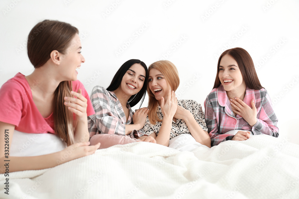 Beautiful young ladies on bed at pamper party. Women's Day Beautiful young ladies on bed at pamper party. Women's Day