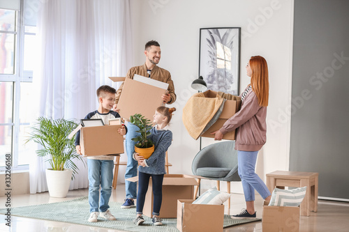Family with moving boxes in...