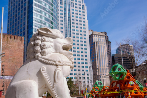 Boston, MA/USA -March 21, 2020: Coronavirus epidemic in China Town City of Boston. Big white statue of Chinese white dragon The Sculpture of the Dragon on the Street Chinese Totem