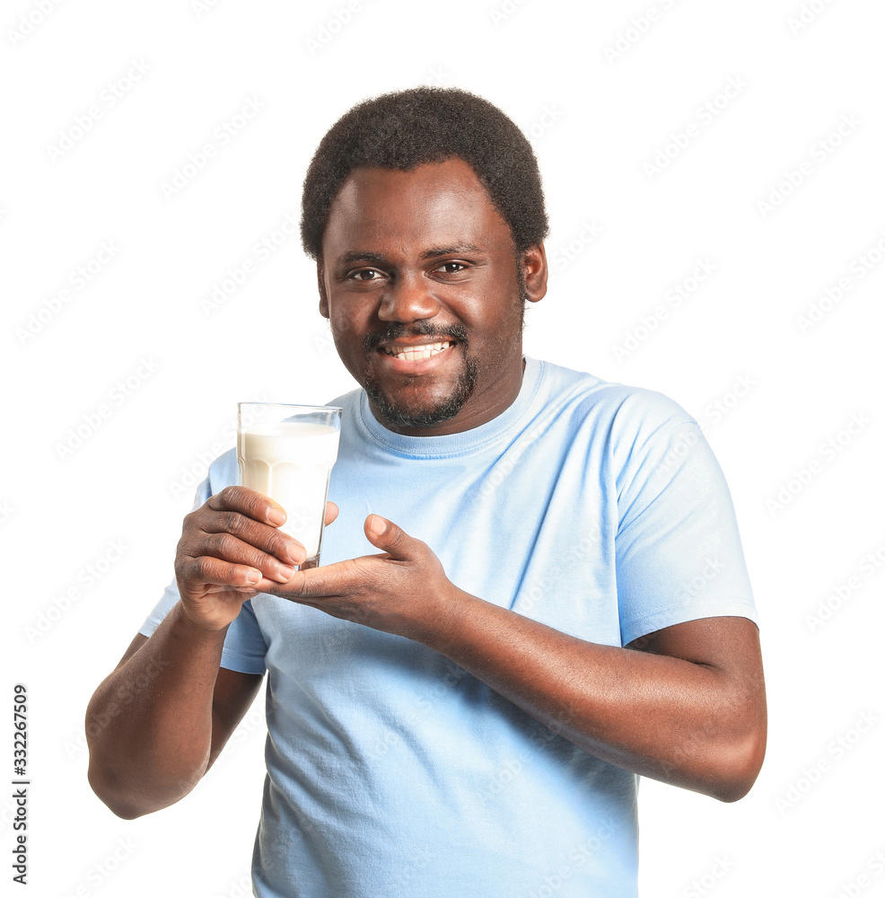 Young African-American man with milk on white background Young African-American man with milk on white background