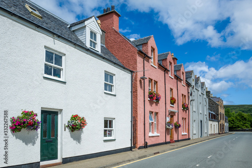 Colorful houses dwcorated with flowers. Portree street, Skye island, Scotland.