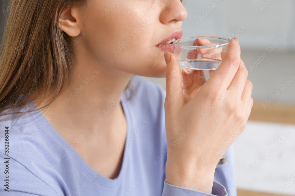 Beautiful young woman drinking water at home, closeup Beautiful young woman drinking water at home, closeup