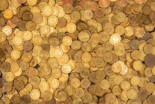 Bed of small golden coins with fairytale halo