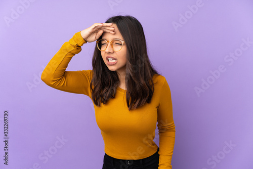 Young mixed race woman isolated on purple background looking far away with hand to look something © luismolinero