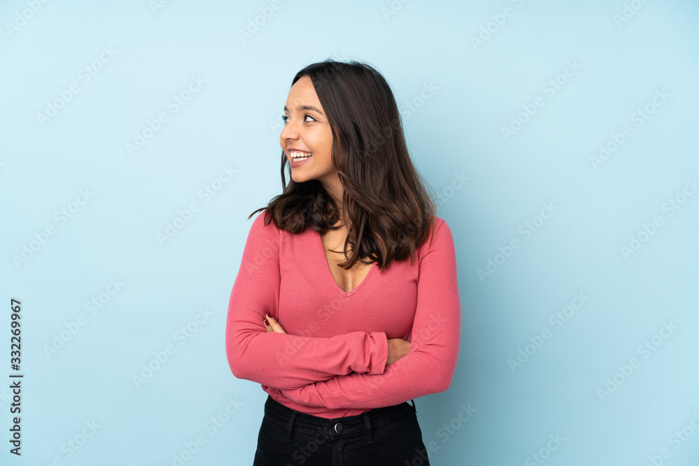 Young mixed race woman isolated on blue background happy and smiling Young mixed race woman isolated on blue background happy and smiling
