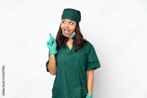 Surgeon woman in green uniform isolated on white background intending to realizes the solution while lifting a finger up