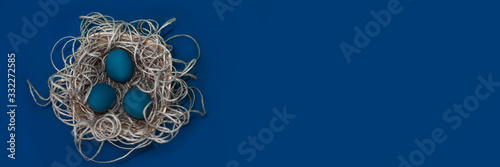 Photography Easter concept, blue easter eggs lie in a basket, free space for text, banner, i