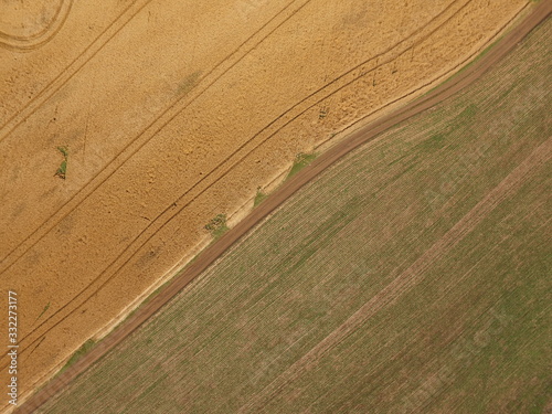 Aerial drone image of a Brazilian soybean crop at early development on one side and a corn crop at harvest on the other side