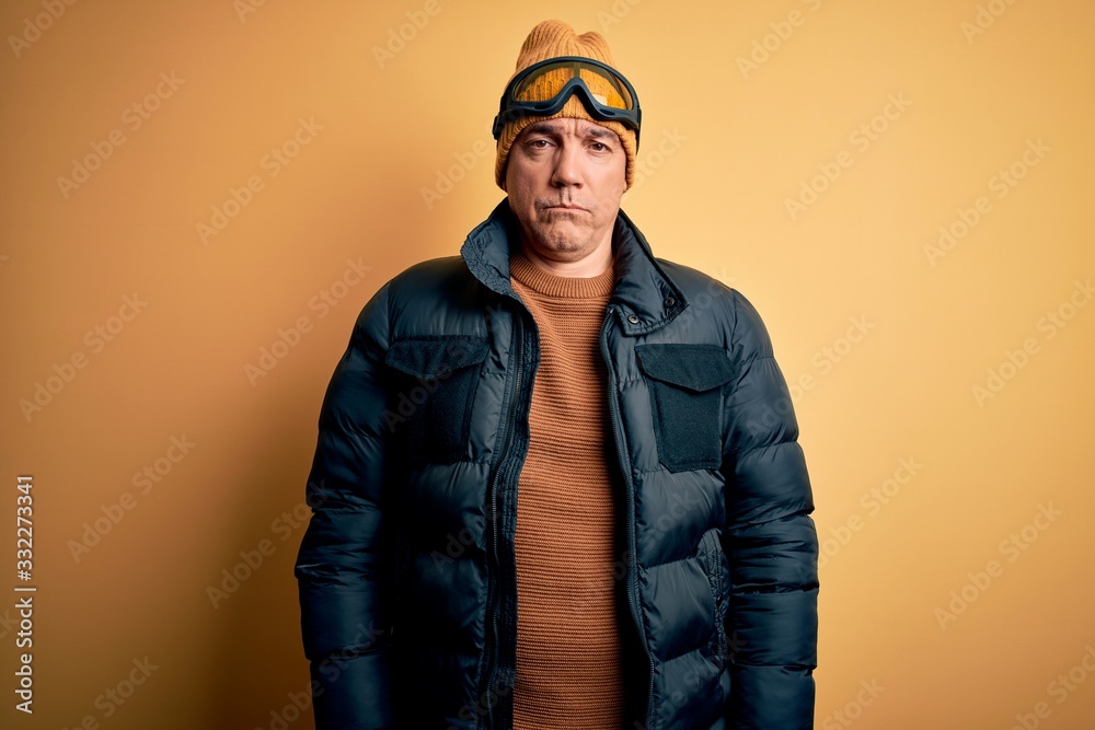 Middle age handsome grey-haired skier man on vacation wearing ski goggles depressed and worry for distress, crying angry and afraid. Sad expression. Middle age handsome grey-haired skier man on vacation wearing ski goggles depressed and worry for distress, crying angry and afraid. Sad expression.