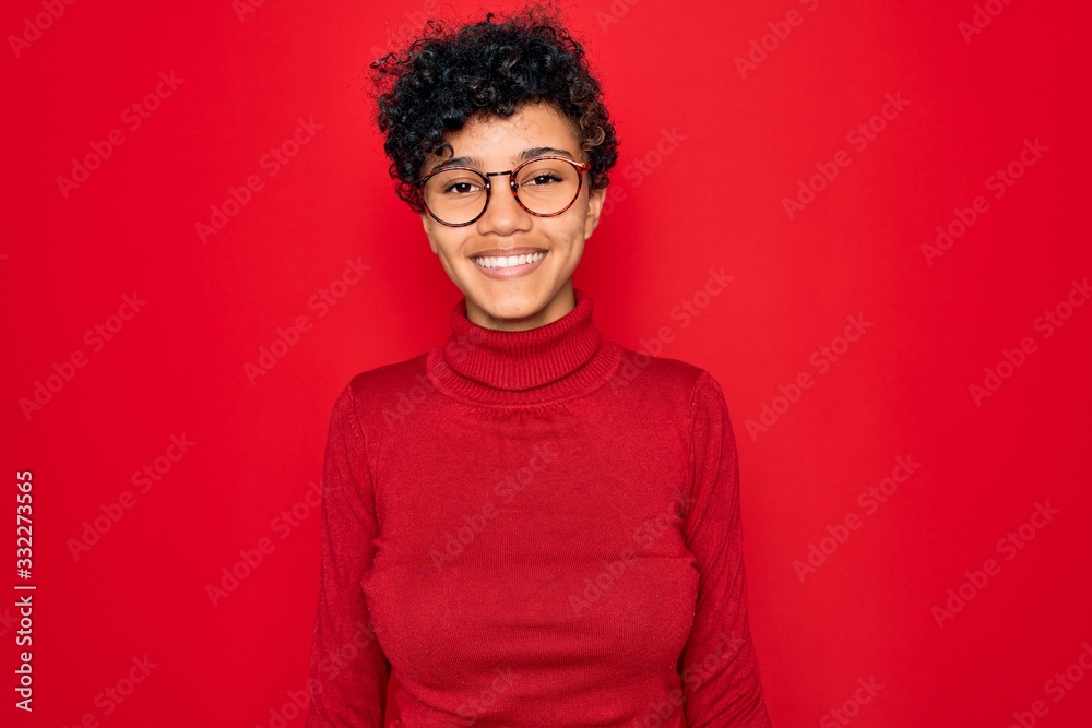 Obraz premium Young beautiful african american afro woman wearing turtleneck sweater and glasses with a happy and cool smile on face. Lucky person.