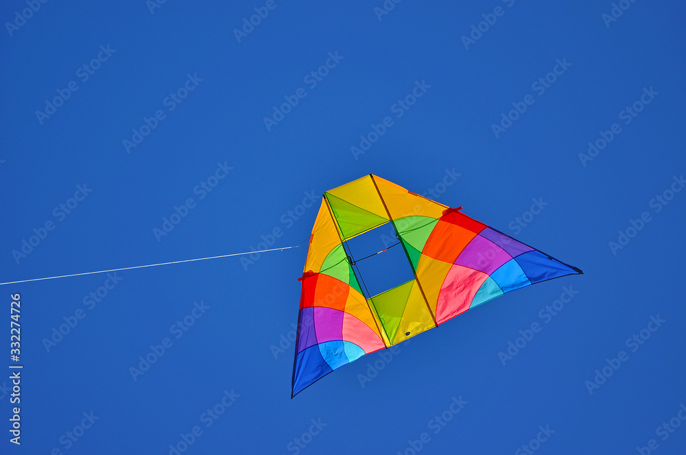 A colorful kite flying in the blue sky