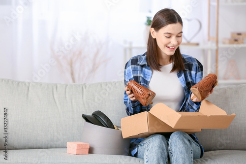 Young woman unpacking parce...