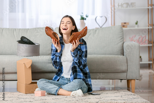 Young woman unpacking parce...